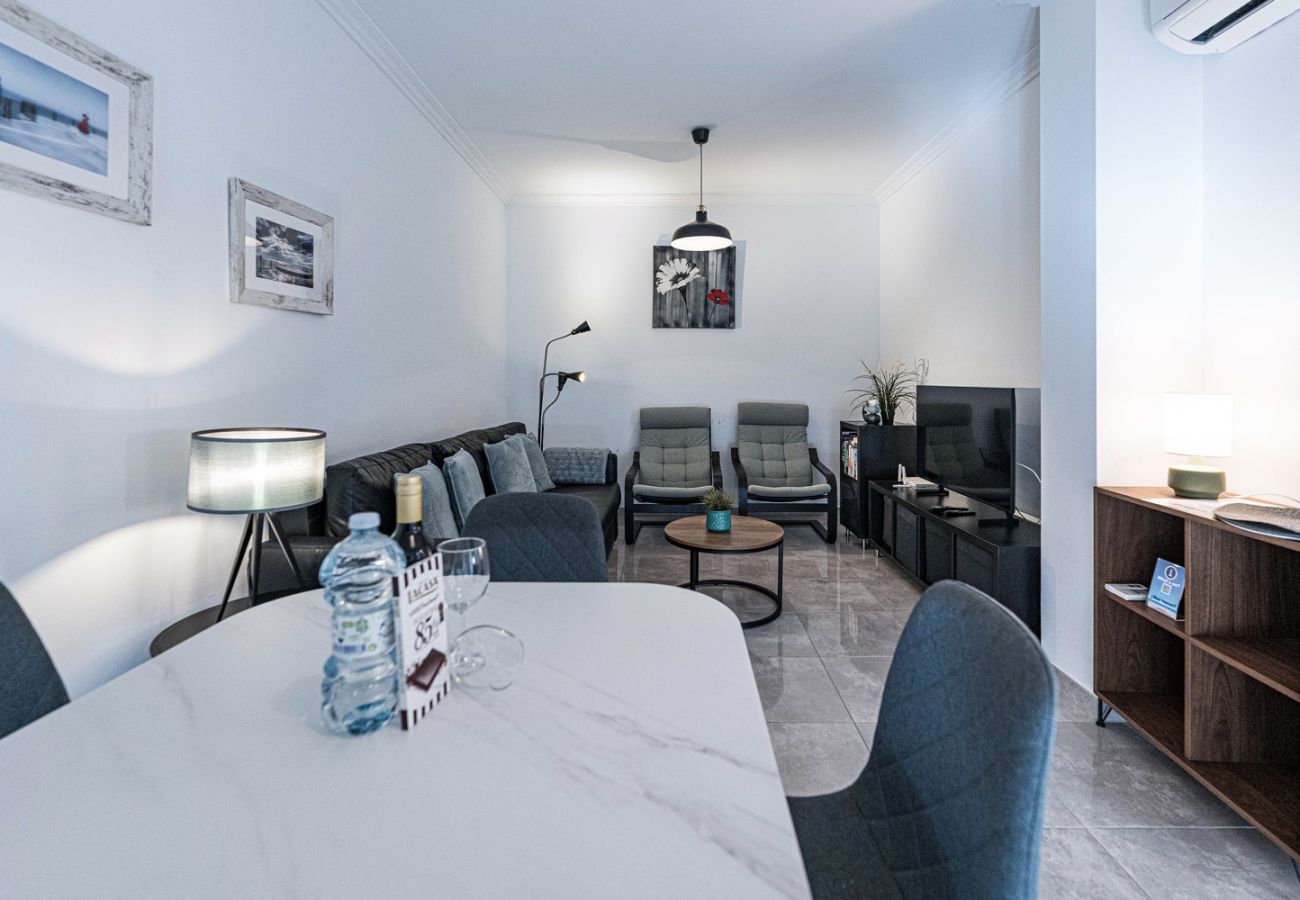 Salón moderno reformado en apartamento Medina Torrecilla Nerja con TV internacional.