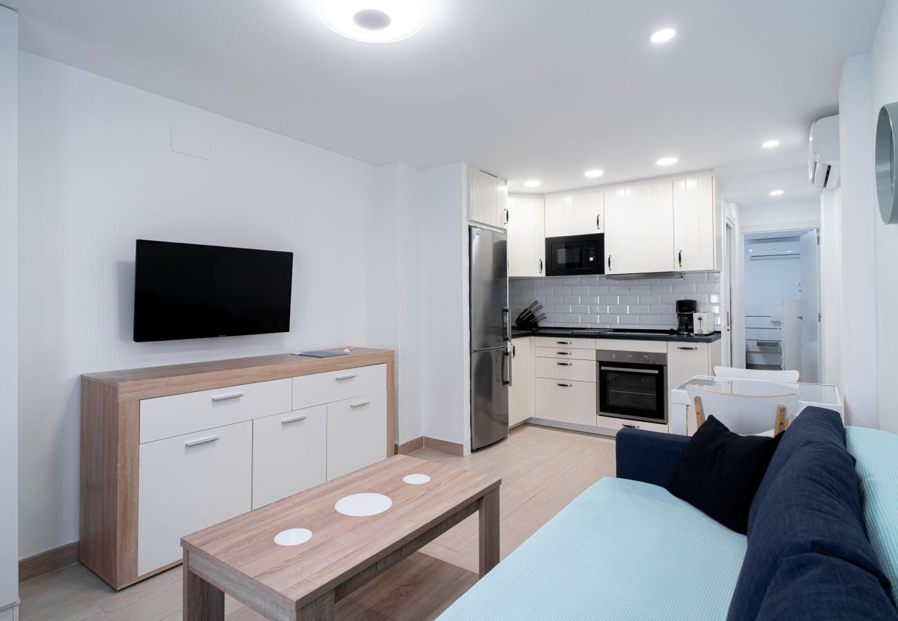 Salón comedor luminoso con cocina americana abierta en el apartamento Arce 2.
