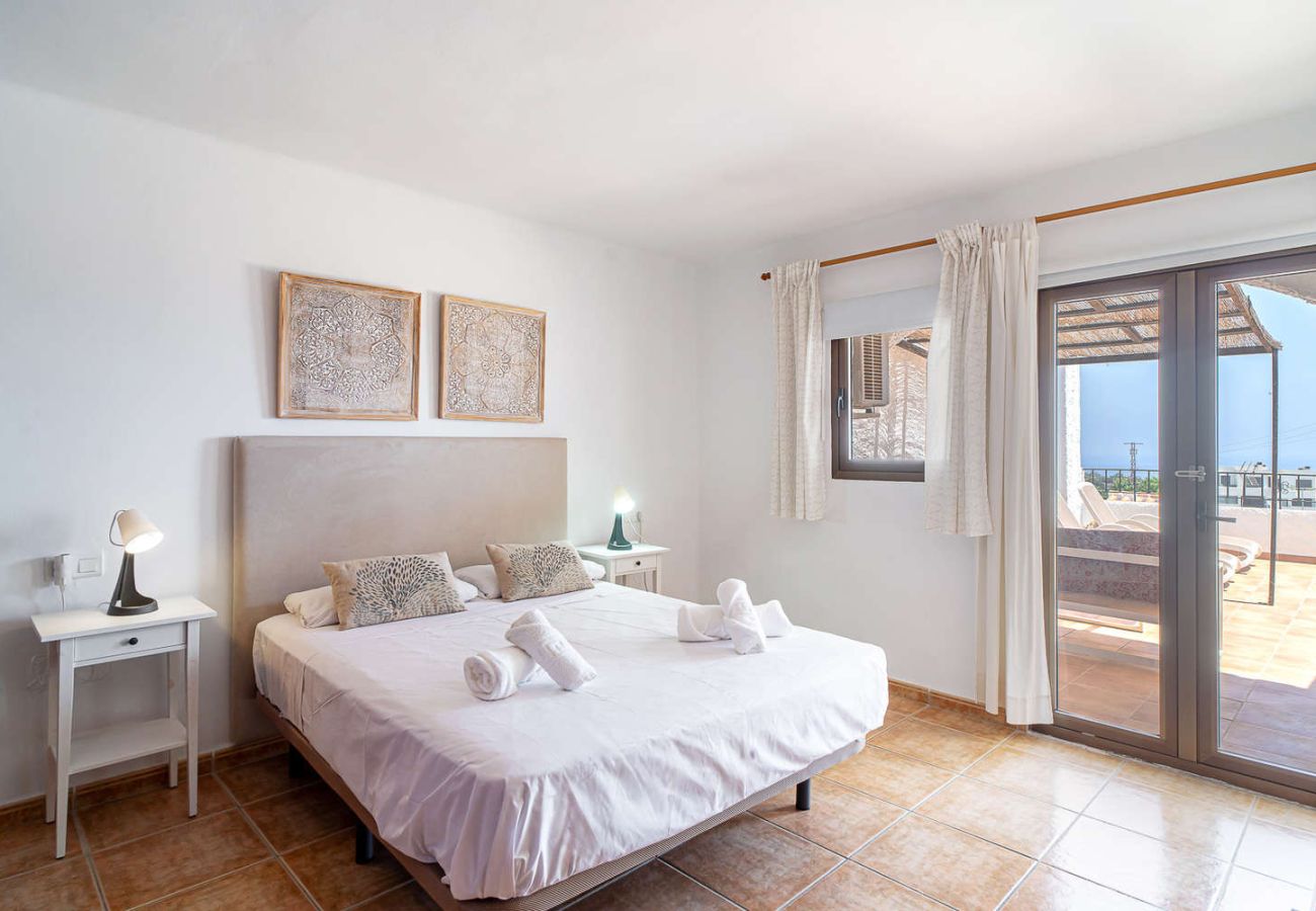Master bedroom with double bed and direct access to the large sunny terrace.