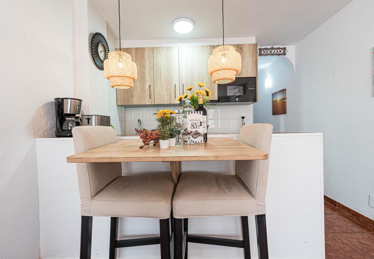 Dining area and open kitchen with Casasol welcome pack: wine and chocolates.