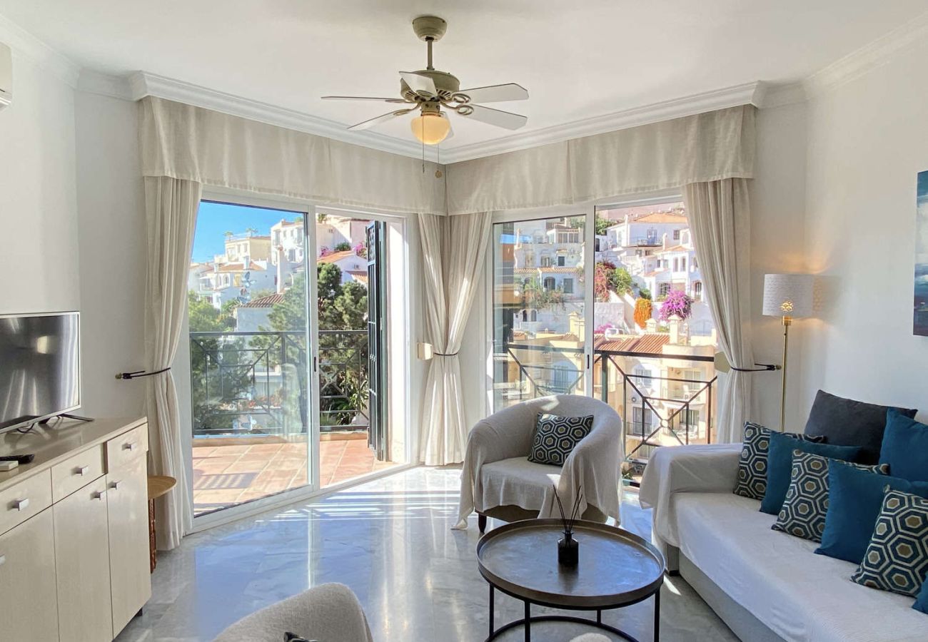 Spacious living/dining room with sofa bed in Villa Lucena, ideal for families.