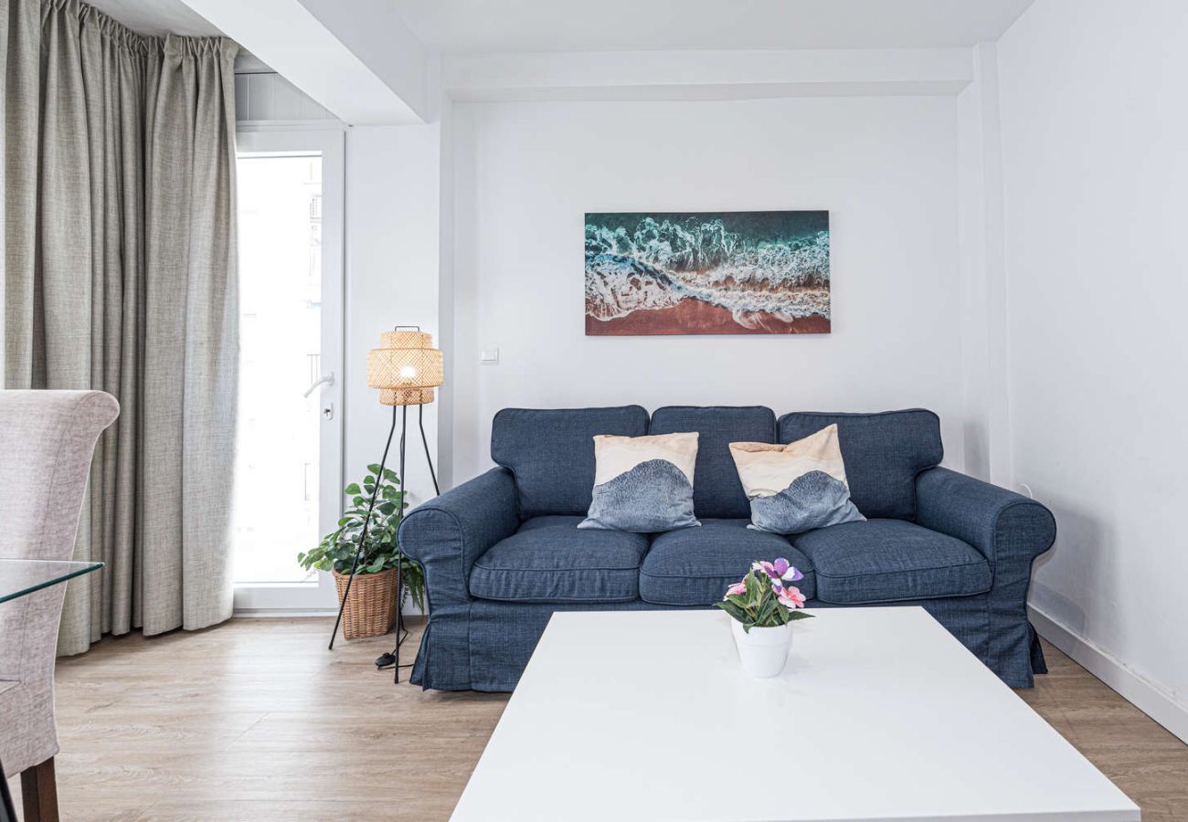 Cosy living room with comfortable sofa and plenty of natural light near the beach in Nerja.