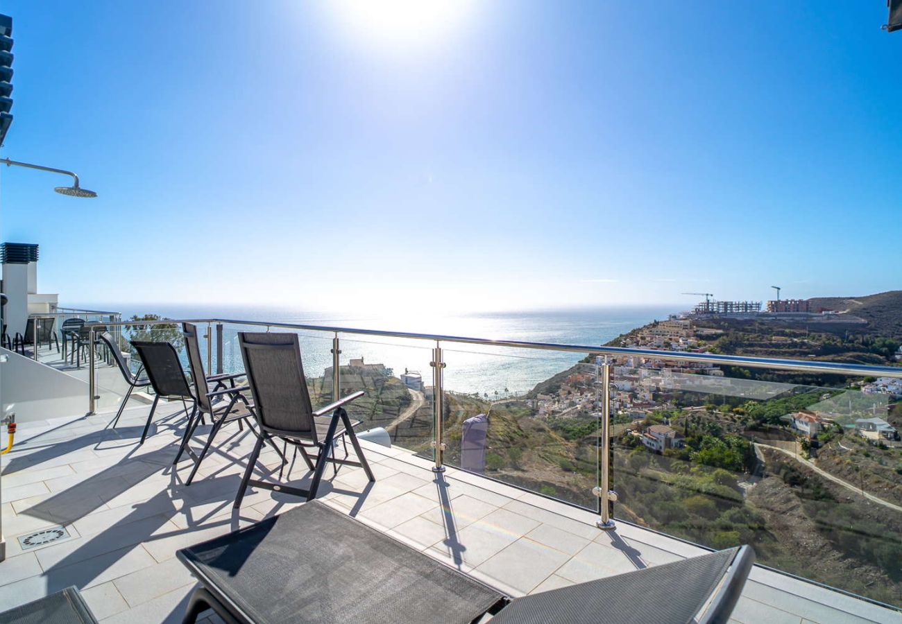 Private rooftop solarium with BBQ, sun loungers, and sea views in Nerja duplex penthouse.