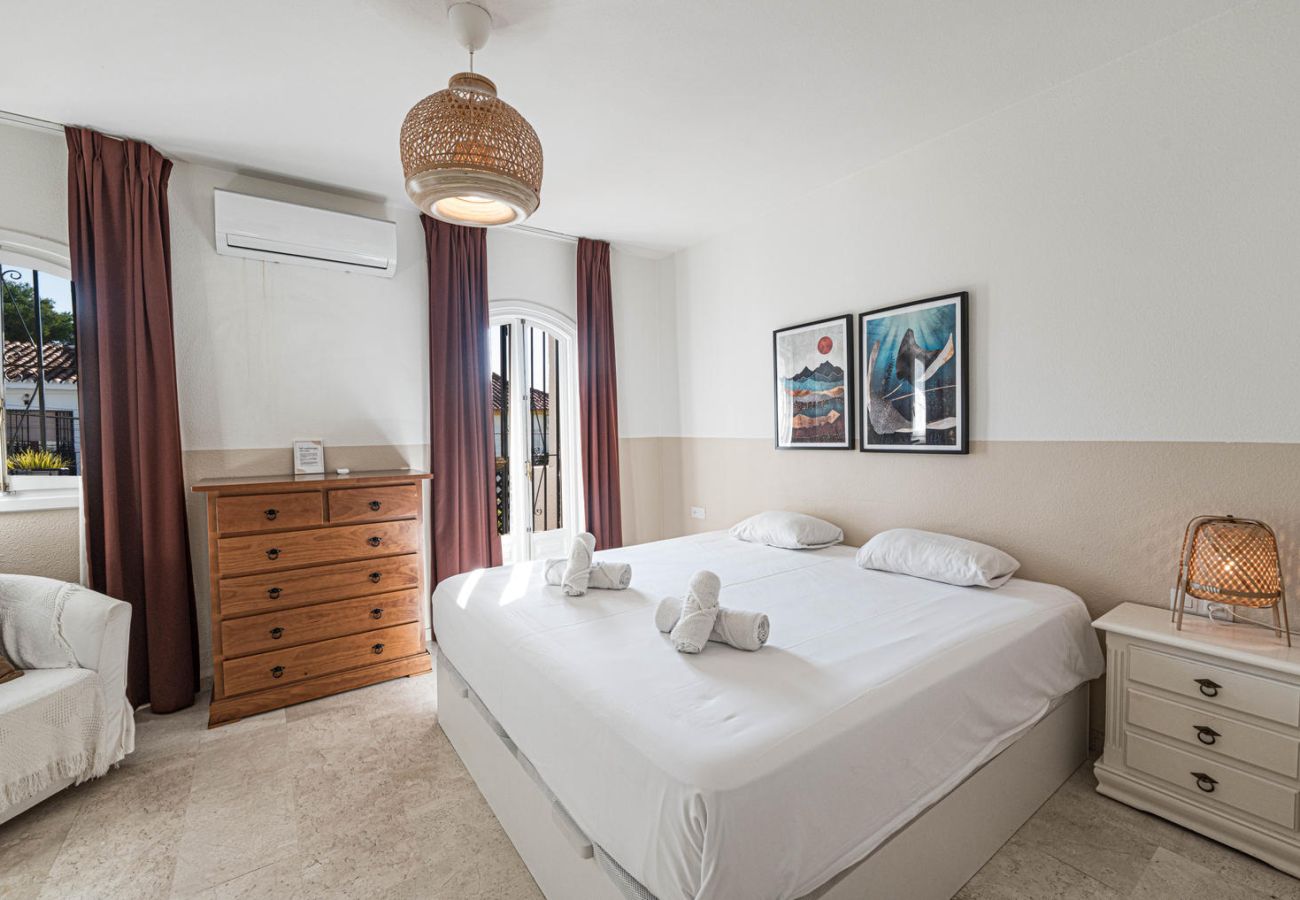 Master bedroom with double bed, private balcony and cosy décor in Nerja.
