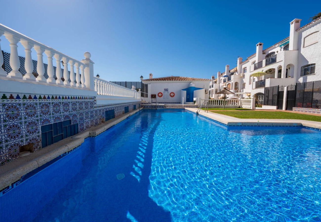Communal swimming pool surrounded by gardens in the Verano Azul residential area, Nerja.