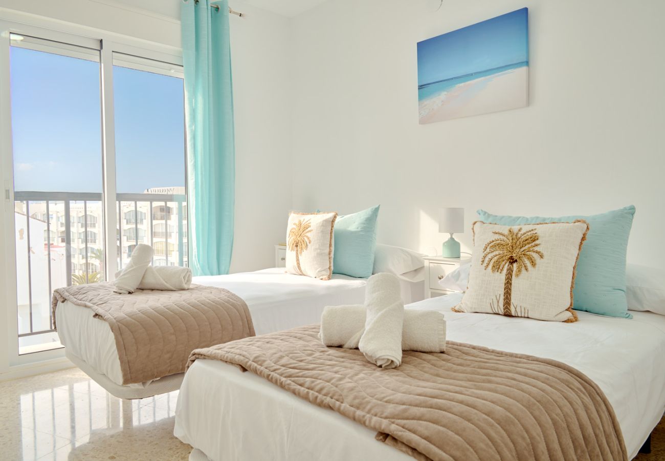 Bright twin bedroom with natural light in Tucuman 3 apartment, Nerja.