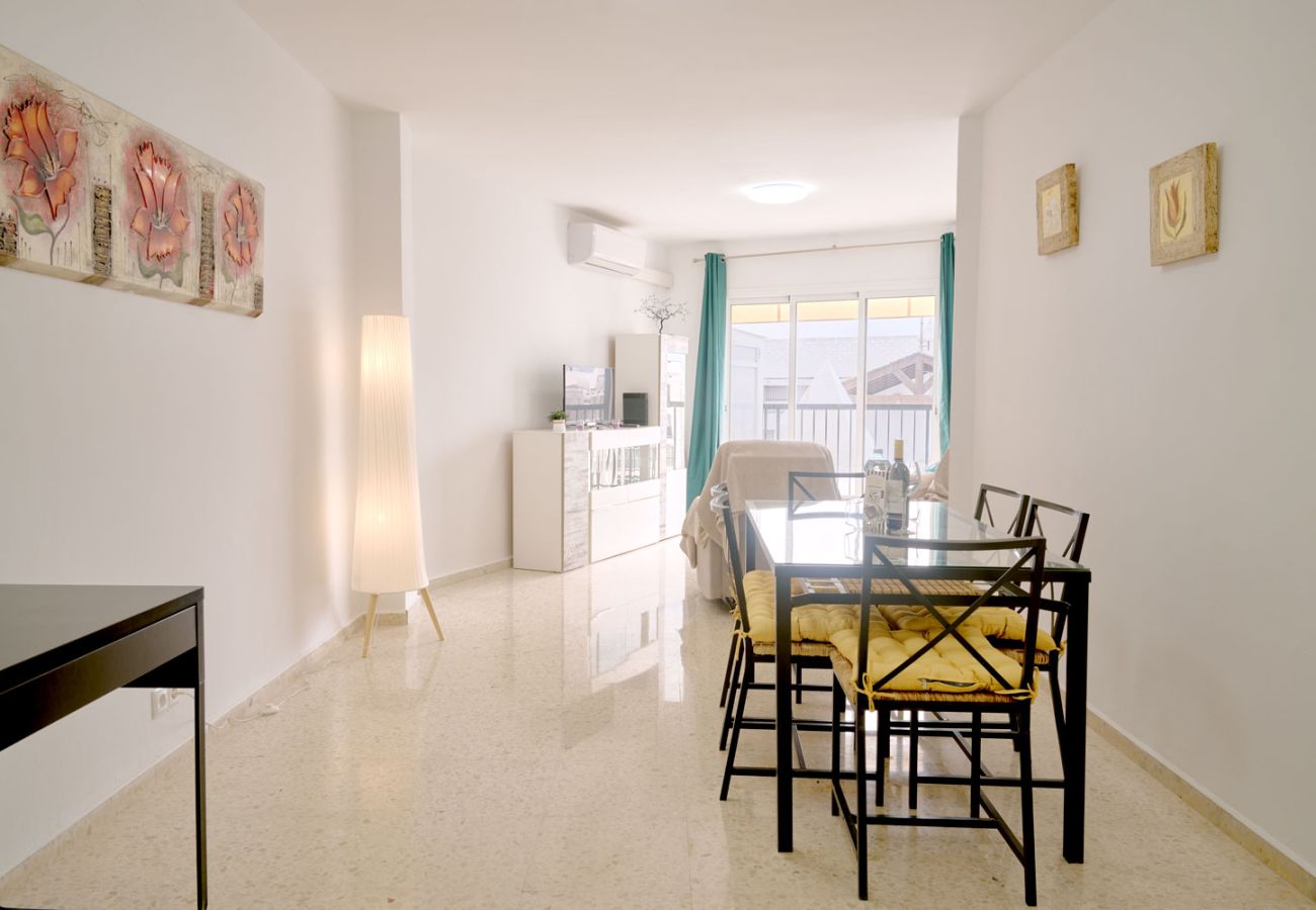 Sunny living and dining area with dedicated workspace in Los Huertos, Nerja.