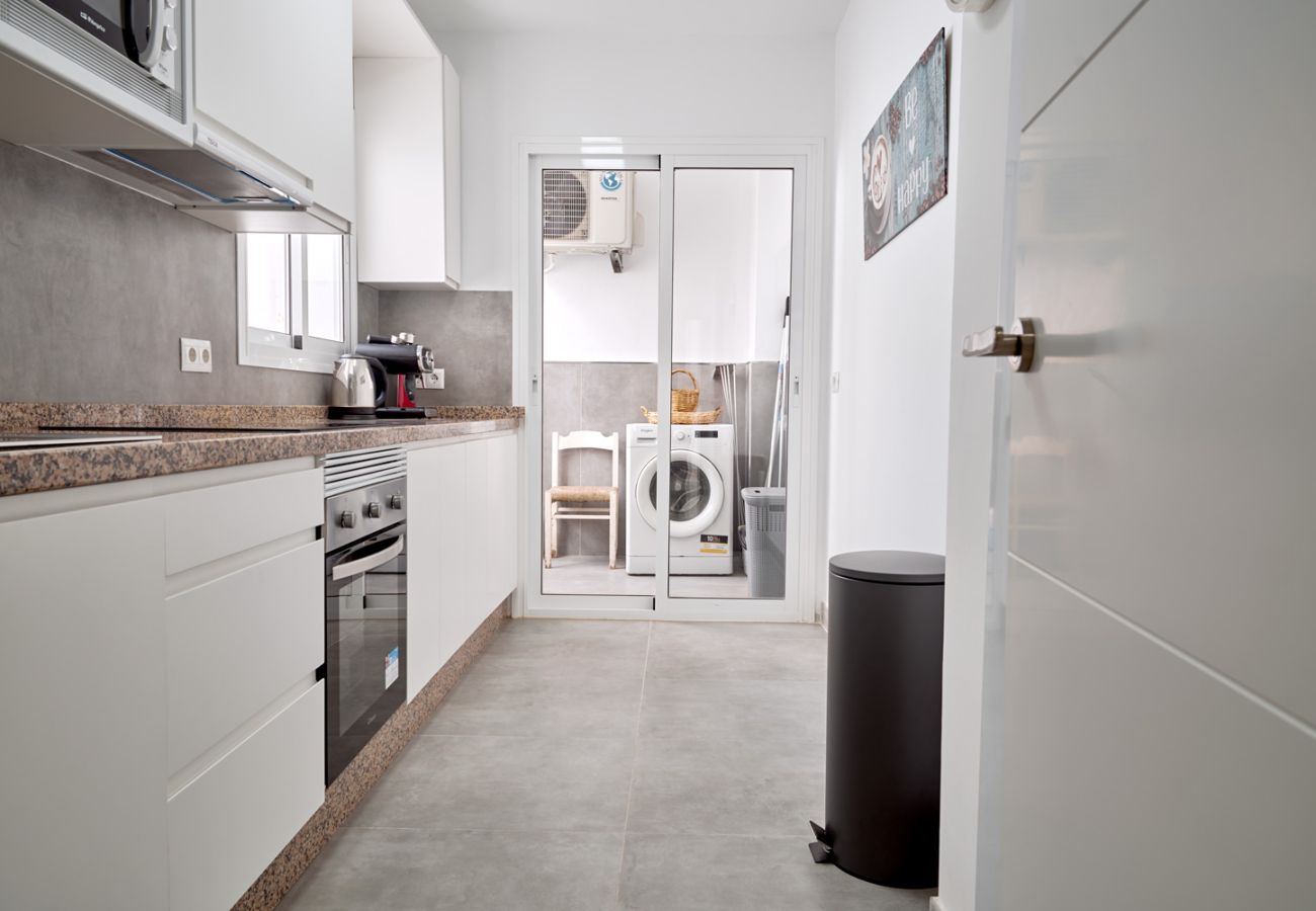 Spacious equipped kitchen with interior patio and washing machine in Nerja.