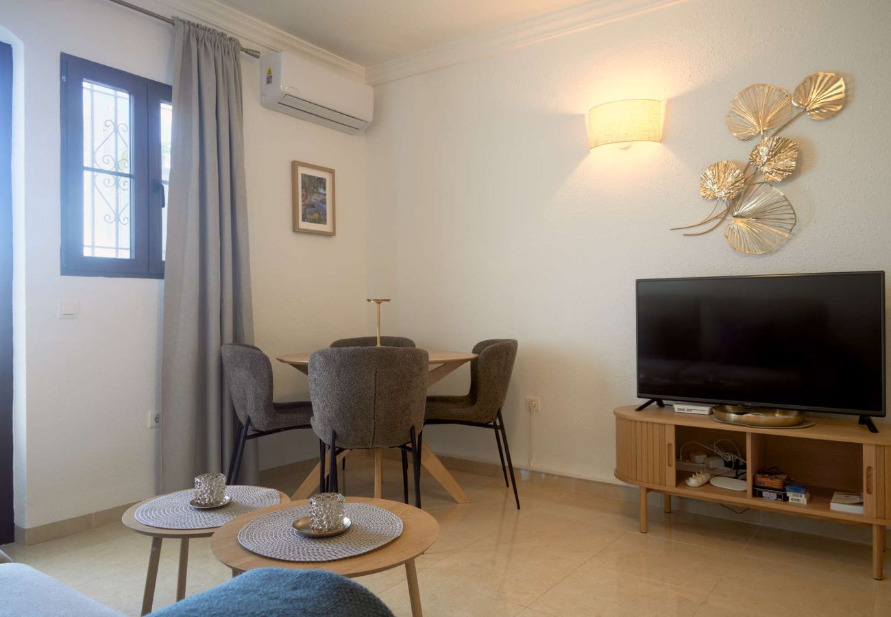 Bright interior of the living and dining area with terrace access in Capistrano Village Nerja.