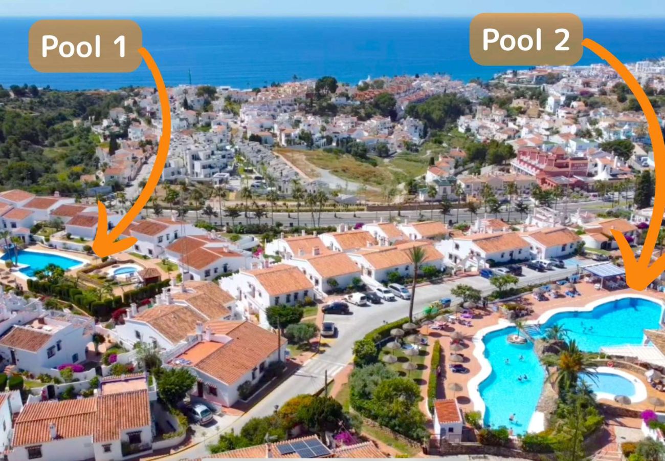 Aerial view of Capistrano Village Nerja showing the white houses and the two communal pools.