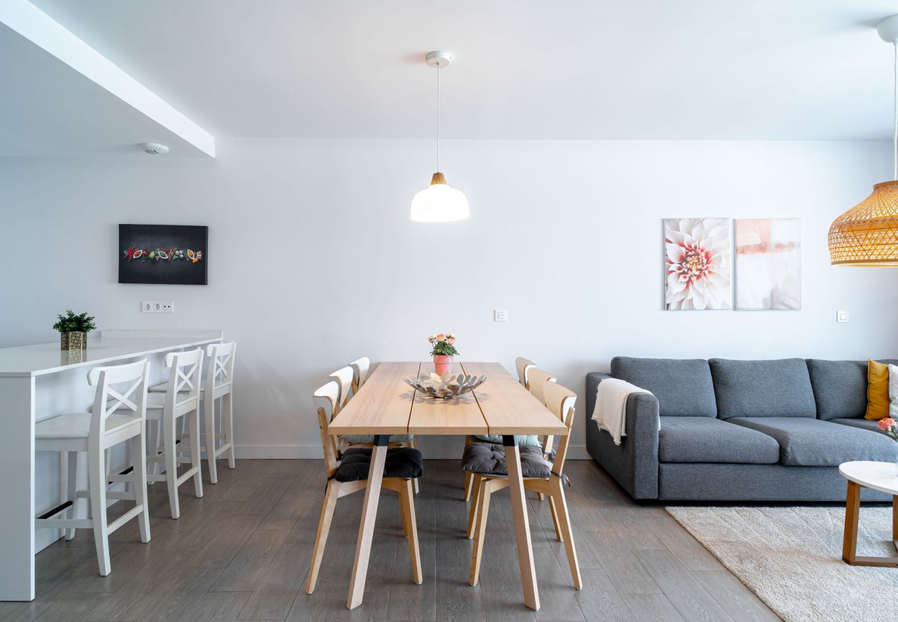 View of the dining table inside the living room at Duna Beach apartment.